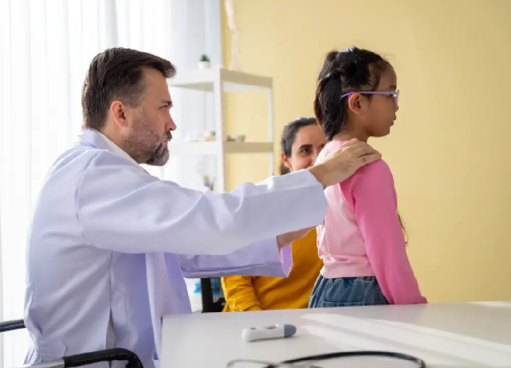 performing a physical exam on a young child during a routine checkup.