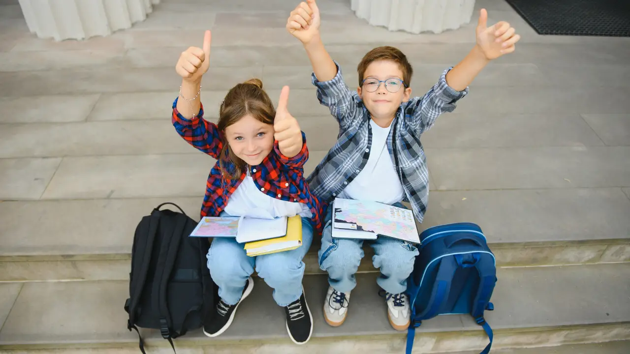 Group of elementary school children reading books outdoors during a back-to-school class in Katy, Texas.