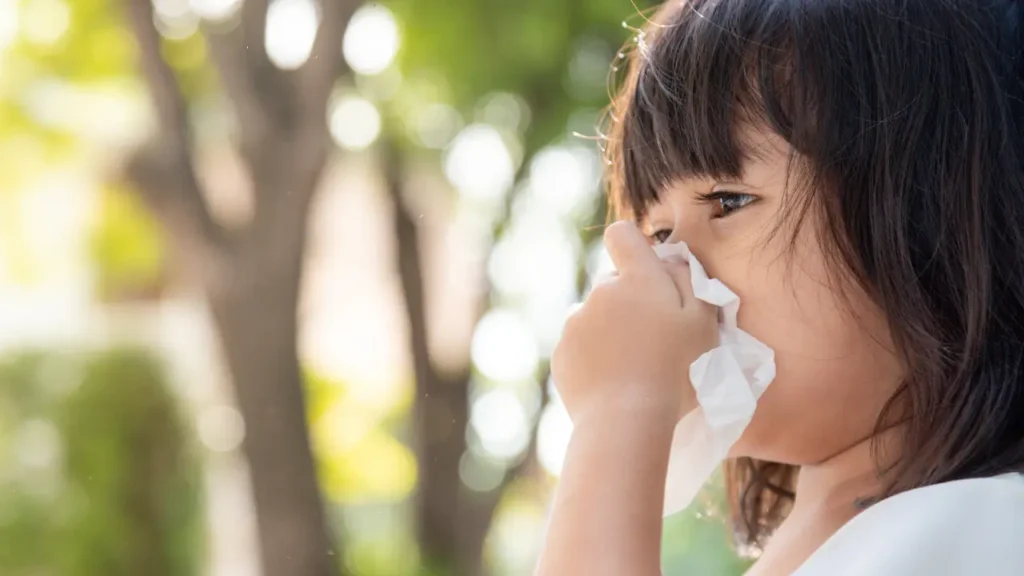 Child experiencing seasonal allergies in Katy, TX, showing sneezing and discomfort, highlighting pediatric allergy care and seasonal allergy management