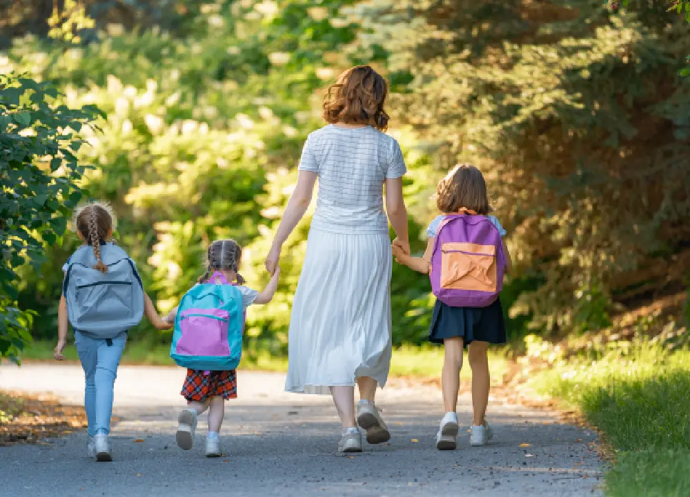 Parent helping children get ready for school with backpacks and lunchboxes, preparing for a healthy and successful school year.